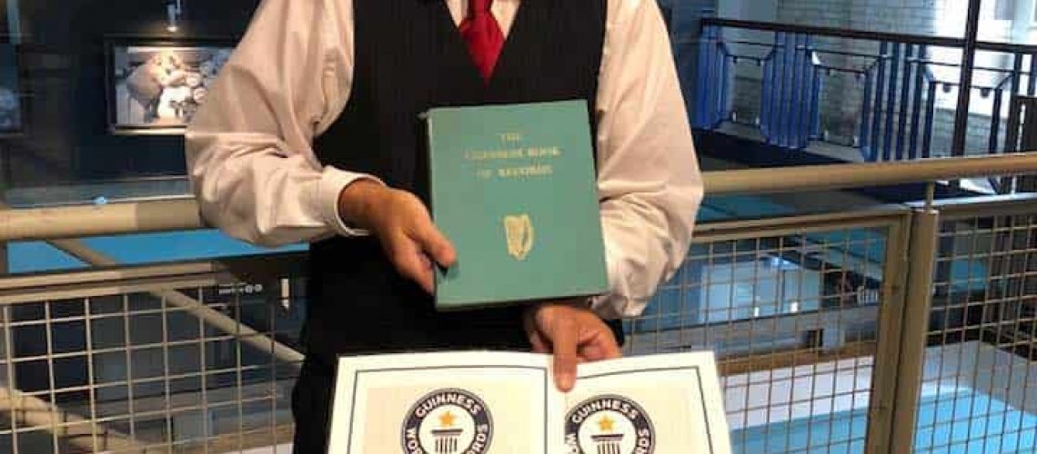 Holding the original 1955 Guinness Book of World Records